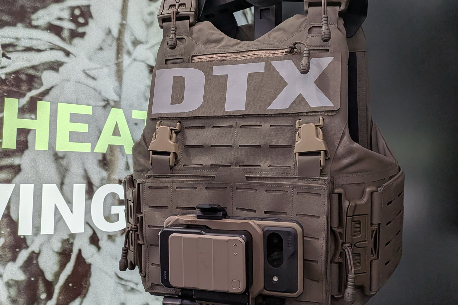 A GoTAK hardened Android end user device mounted to a plate carrier chest rig in a MAAK mount