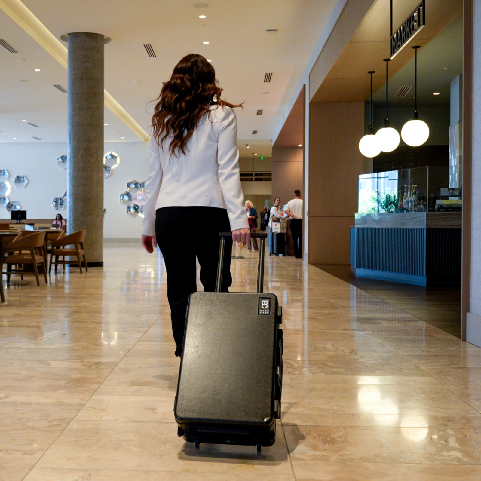 Base Case wheeled through a terminal as a carry-on