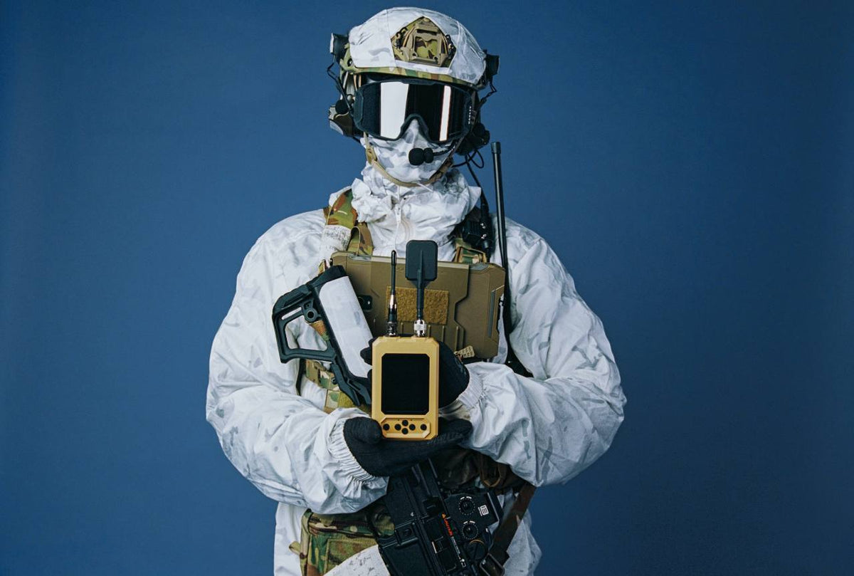 MOTH spectrum analyzer held by an operator in winter camouflage