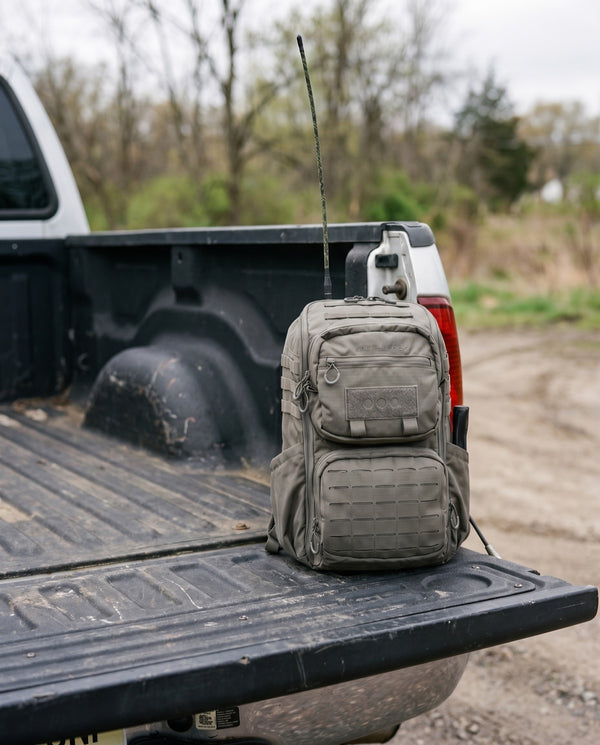 RADIO MANPACK zipped in the Eberlestock pack, antenna up, sitting in the truck bed